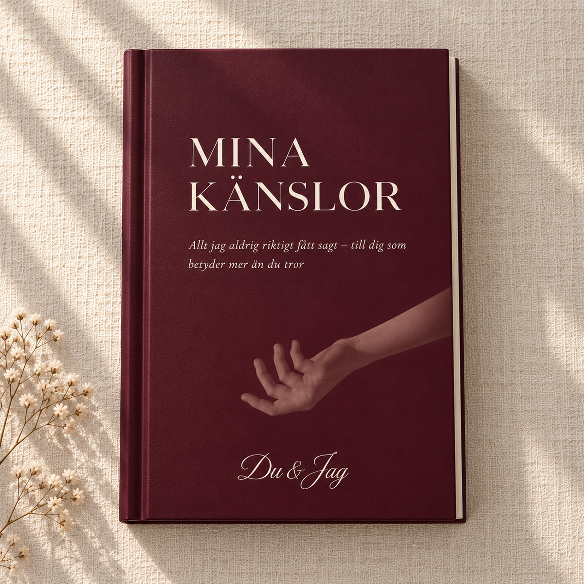 Mina Känslor – vinröd bok med hårda pärmar, ljus text och en utsträckt hand på omslaget